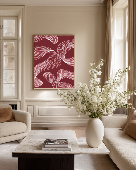 Living room with a large dark red abstract painting, white flowers in a vase, and a marble coffee table.