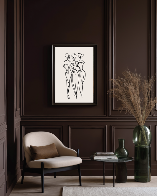 Modern interior with a framed abstract artwork on a dark wall, a beige armchair, and decorative elements.