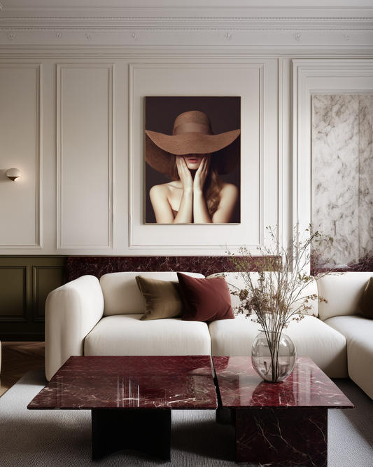 Modern living room with a white sofa, red marble coffee table, and brown fashion wall art.