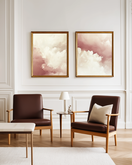 Two brown armchairs in a living room with two matching large abstract pink clouds framed romantic posters on the wall.