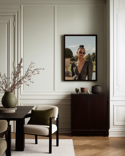 Dining room with a framed portrait on the wall, table, chairs, and decorative elements.