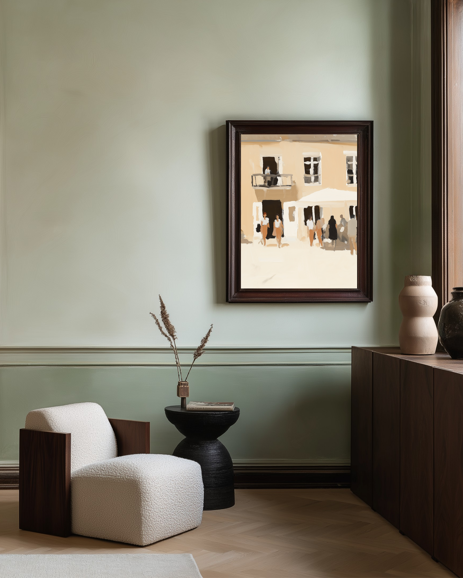 Framed artwork on a wall above a modern armchair and side table.