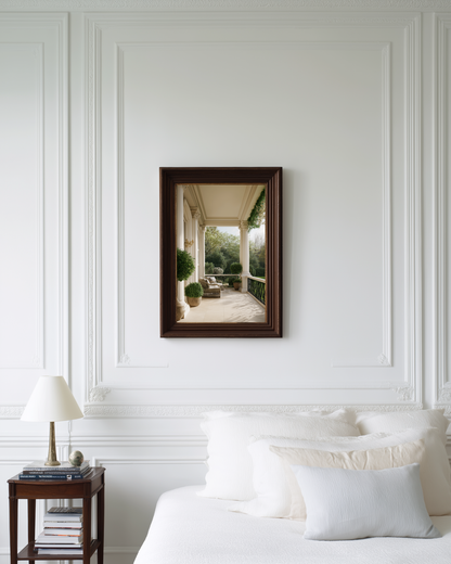 Framed photo wall art on a white wall above a bed with a side table.