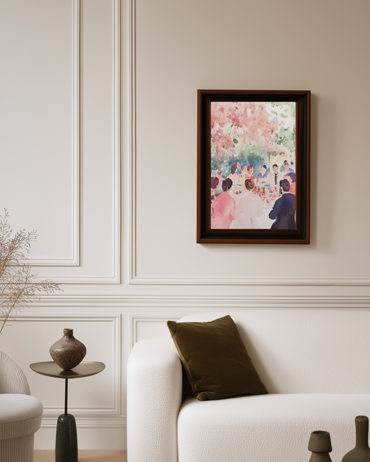 Framed pink watercolor poster on a wall above a white sofa with decorative pillows.