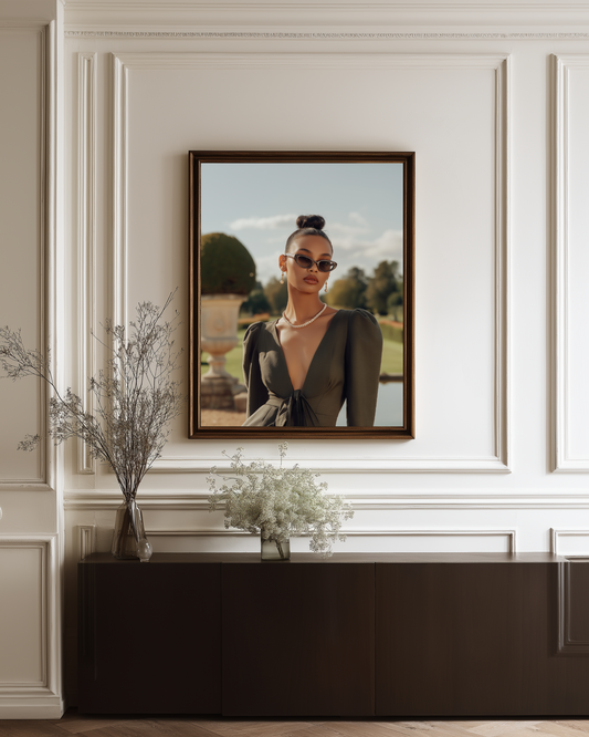 Framed portrait of a woman on a wall with decorative elements below.
