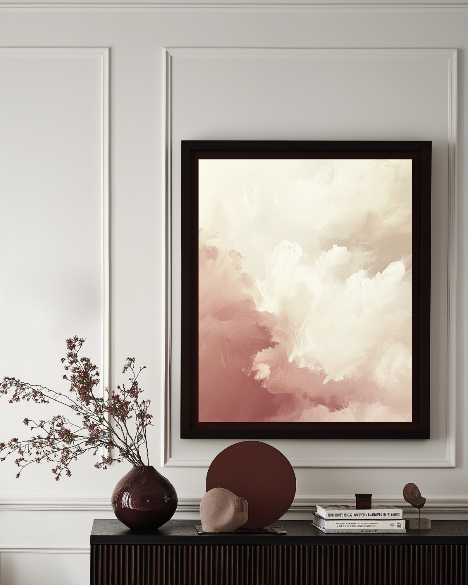 Large abstract pink clouds framed romantic poster on a wall above a console table with decorative items.