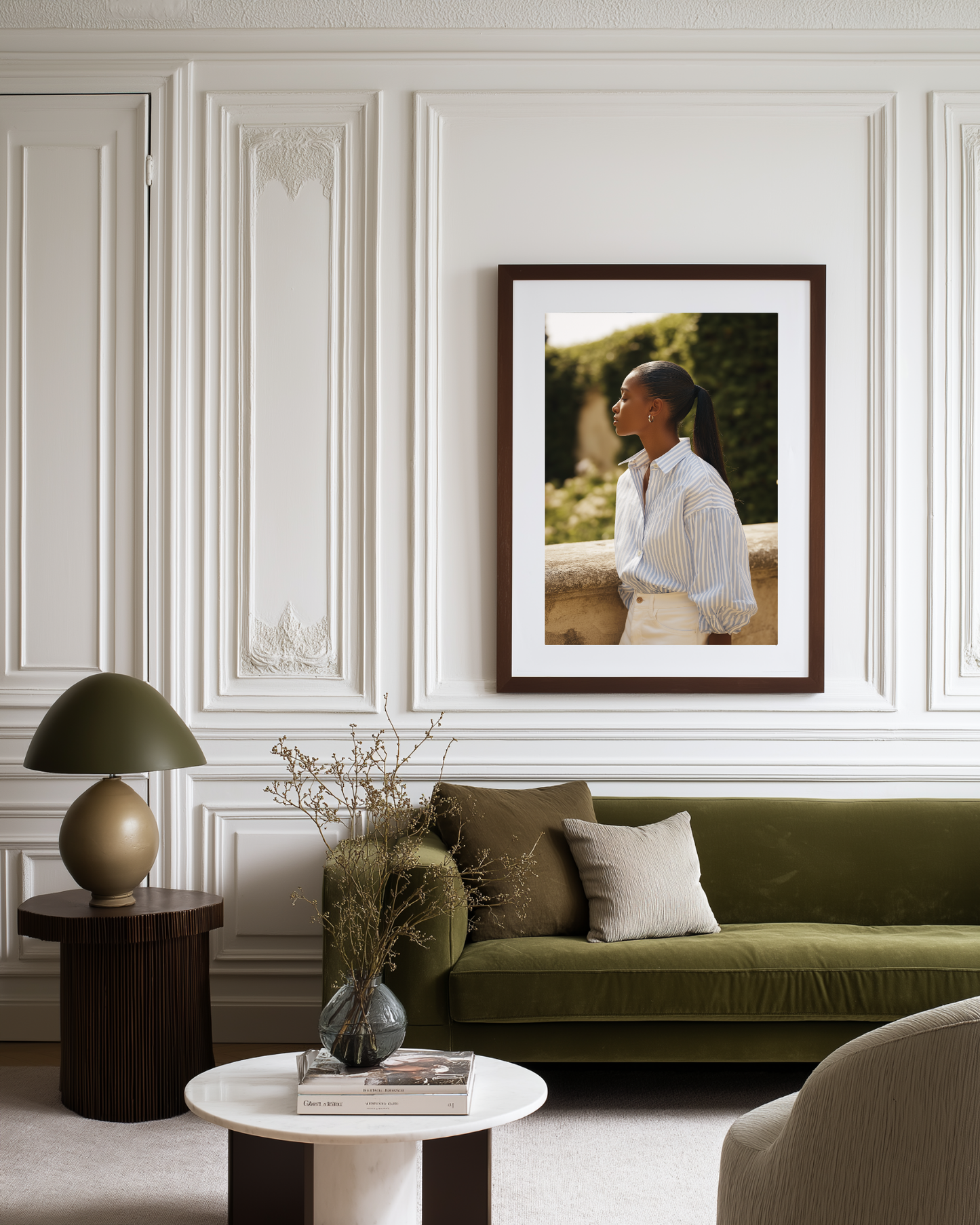 Living room with a green sofa, framed picture on the wall, and decorative items.