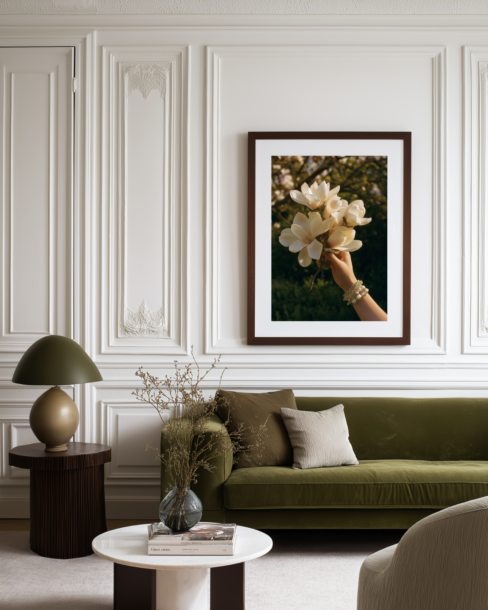 Living room with a green sofa, decorative lamp, and framed poster with flowers on the wall.