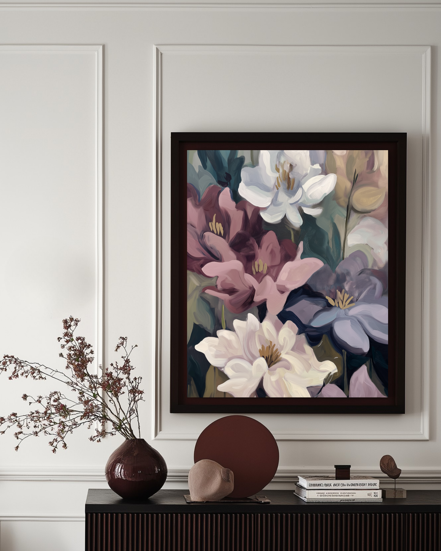 Framed floral artwork on a wall above a console table with decorative items.