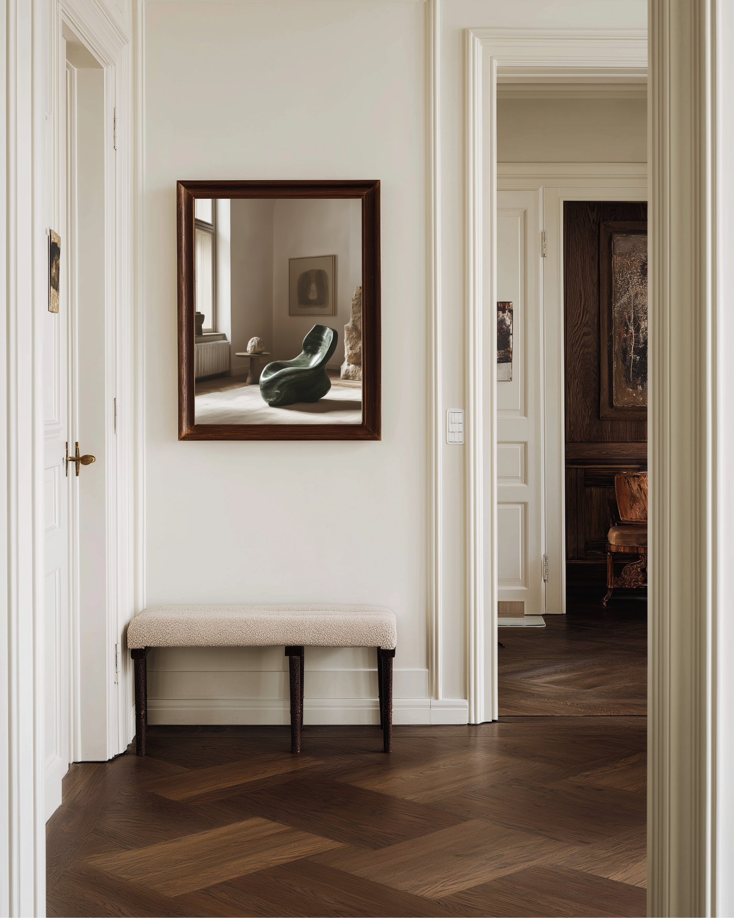 Hallway with a framed photography art print reflecting an interior room, featuring a green chair.
