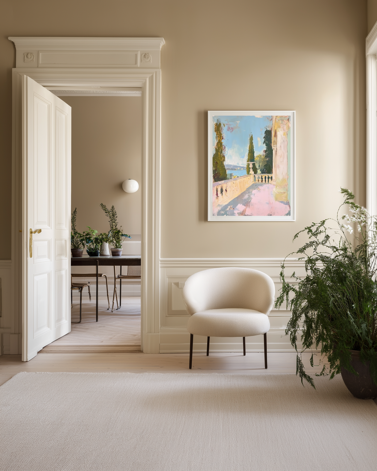 Modern interior with a white chair, potted plant, and framed artwork on a beige wall.