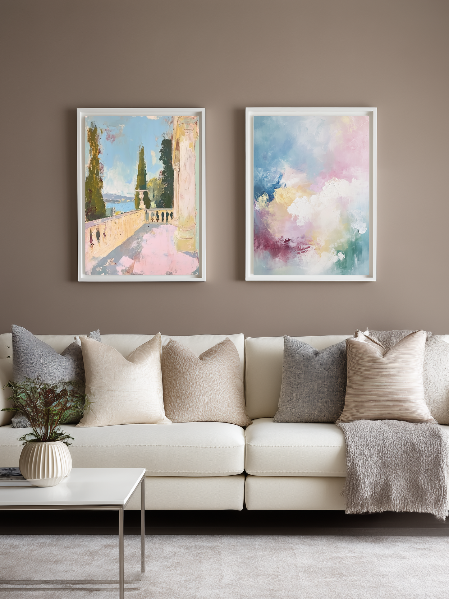 Living room with a beige sofa, decorative pillows, and two framed pastel colored artworks on the wall.