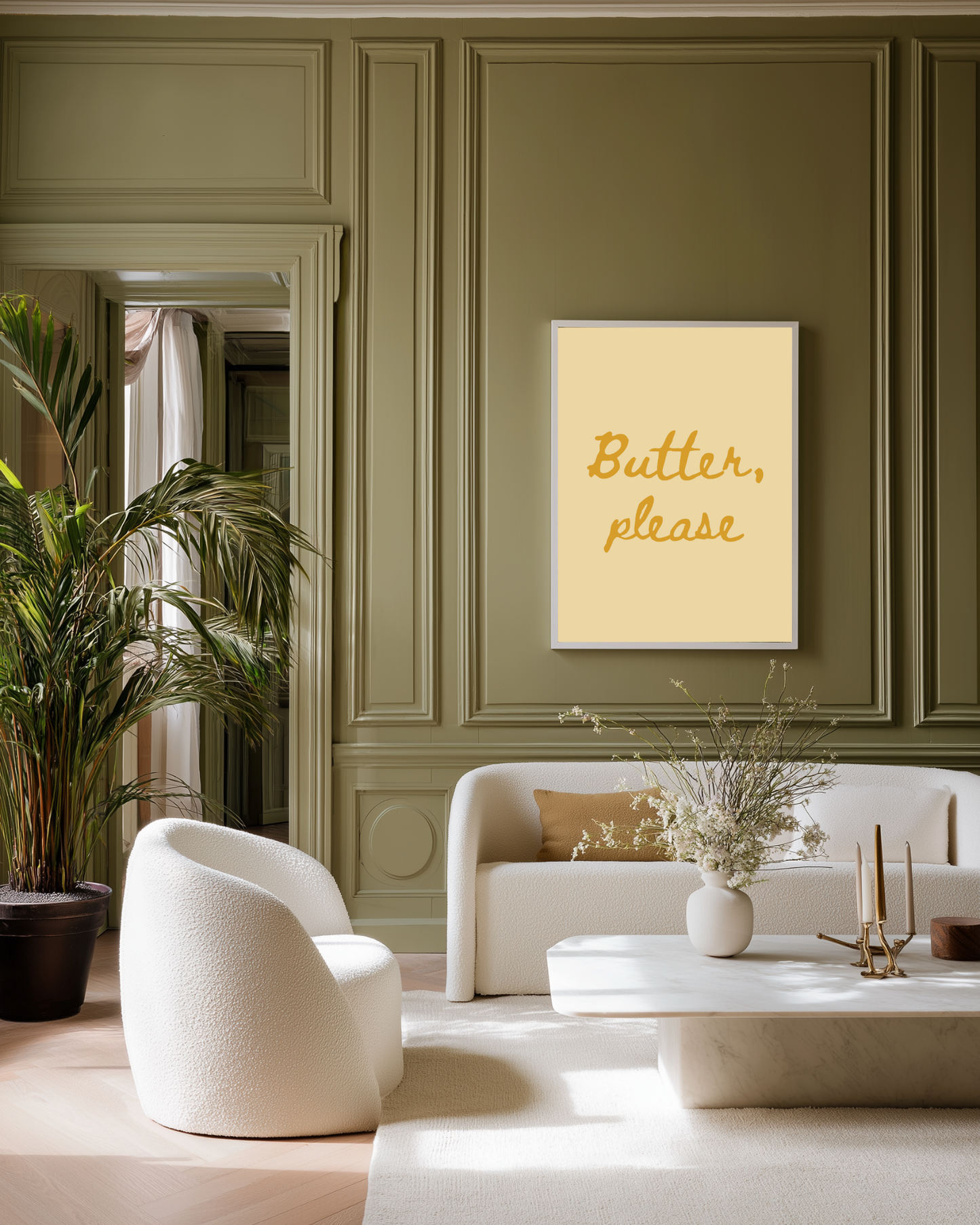 Modern living room with olive green walls and a framed poster print on the wall, white furniture, and decorative elements.
