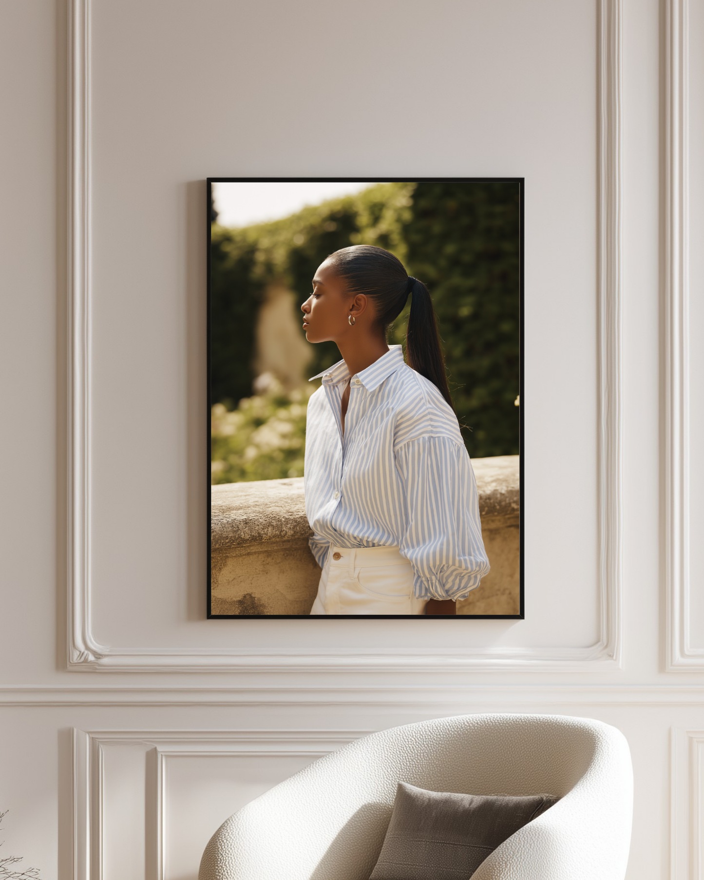 Framed fashion photograph of a woman with a garden background on a wall.