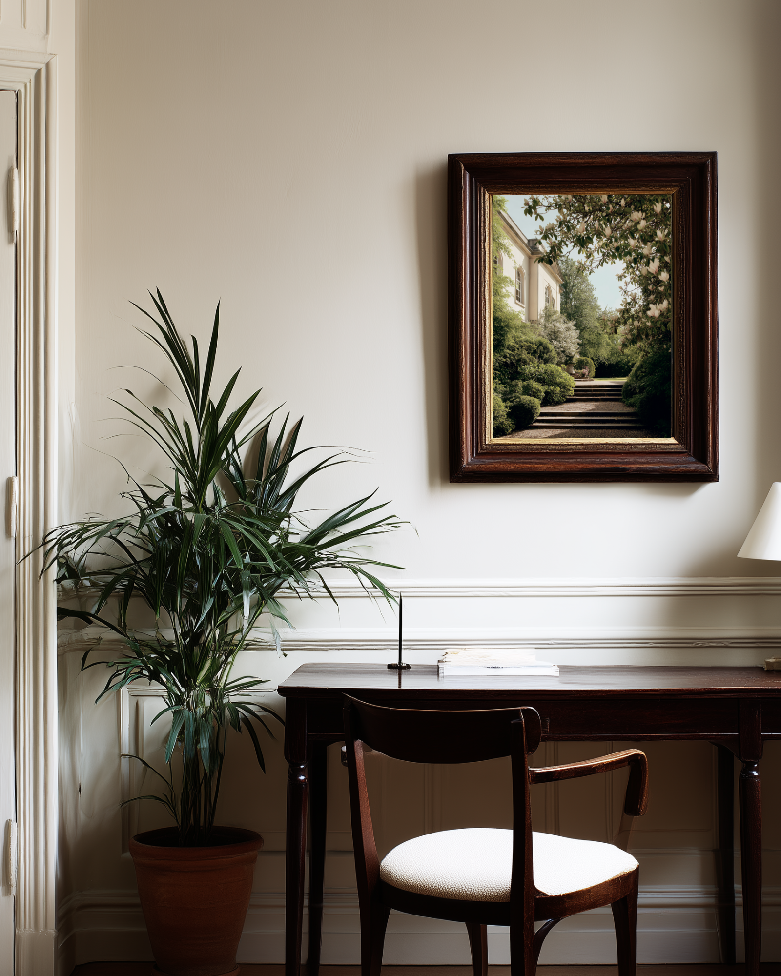 Home office with a desk, chair, and framed picture on the wall.