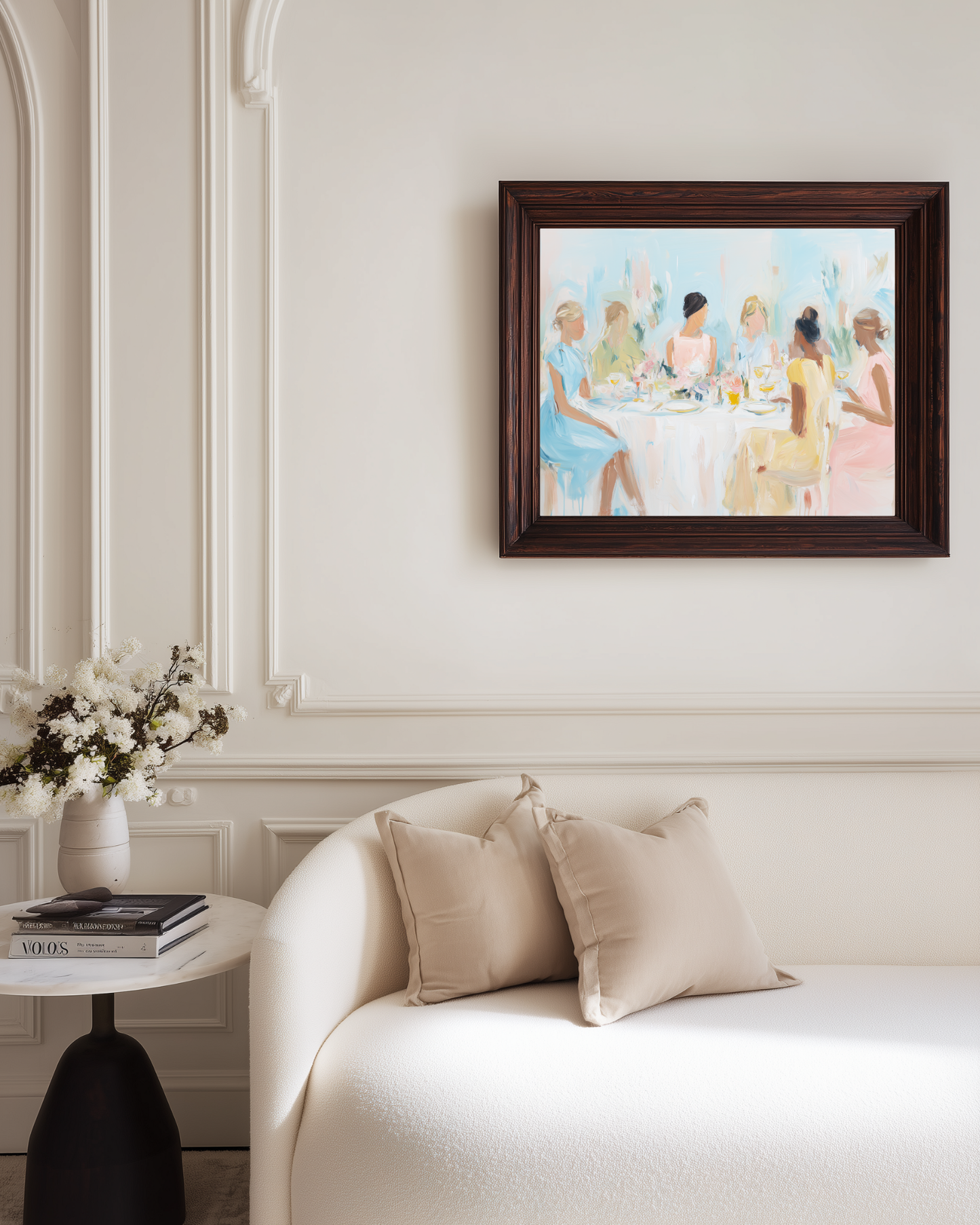 luxury living room with cream white walls and wall art of ladies who lunch in light soft pastels on a wall above a sofa.
