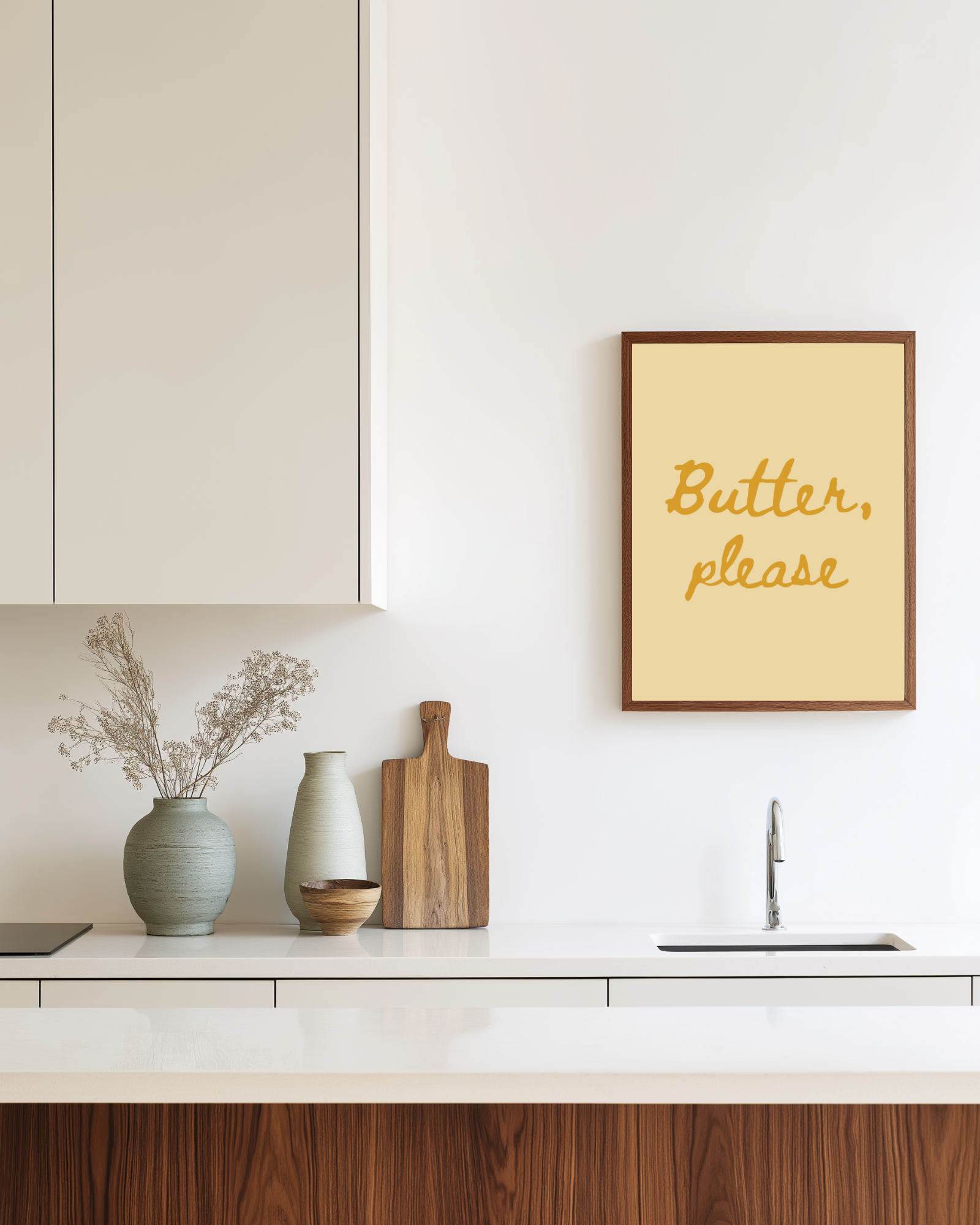 Kitchen counter with decorative items and a framed butter yellow art print reading 'Butter, please'.