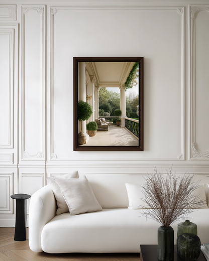 Framed photography poster on a wall above a white sofa in a living room.