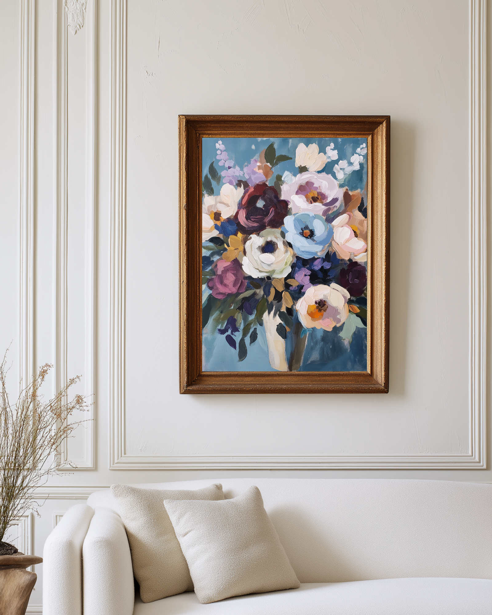Framed floral painting on a wall above a sofa